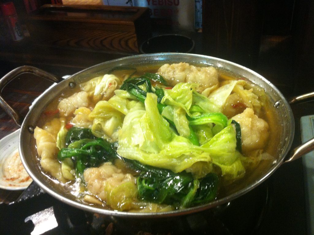 Motsunabe Japanese offal hot pot with vegetables in iron pot, Fukuoka specialty